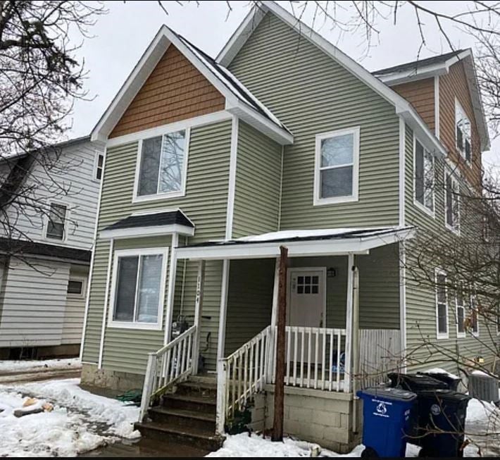 the front of a house with snow on the ground